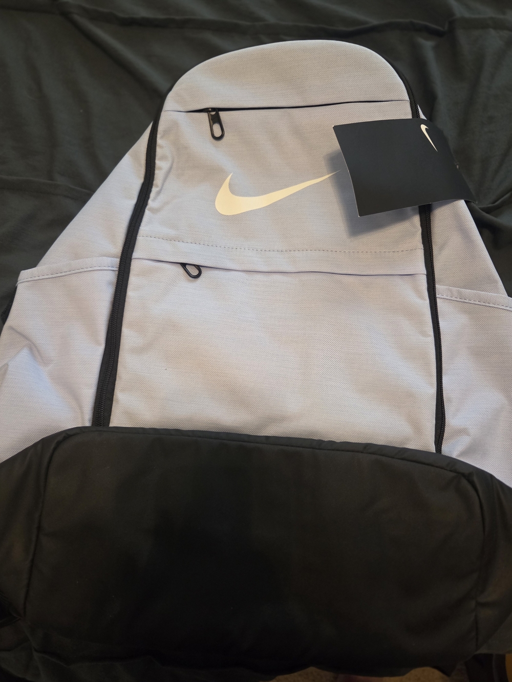 Nike Light Blue and Black Backpack with Swoosh Logo.